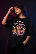 Person wearing a black t-shirt with a graphic design on a dark background