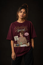 Woman wearing a Maroon t-shirt with a graphic design 