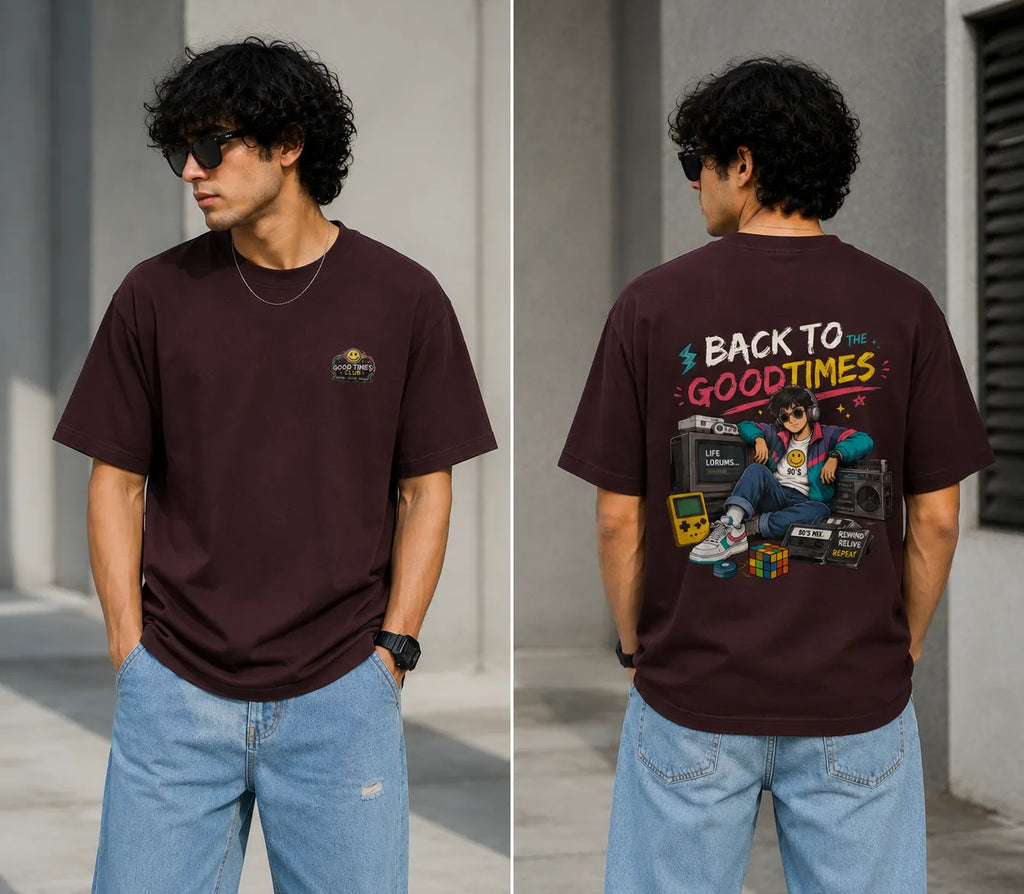 Person wearing a maroon t-shirt with a graphic design on the back, standing outdoors.