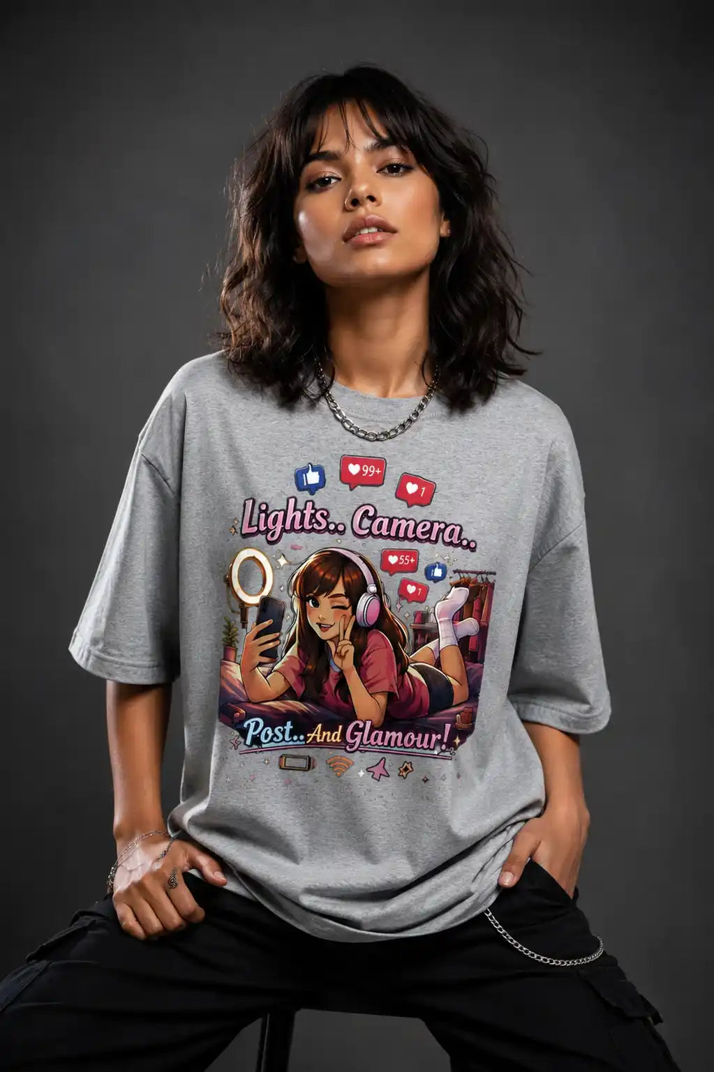 Person wearing a gray t-shirt with a graphic design on a dark background