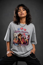 Person wearing a gray t-shirt with a graphic design on a dark background