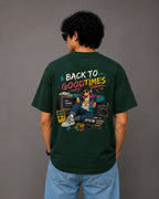 Person wearing a green t-shirt with a graphic design on the back against a gray background