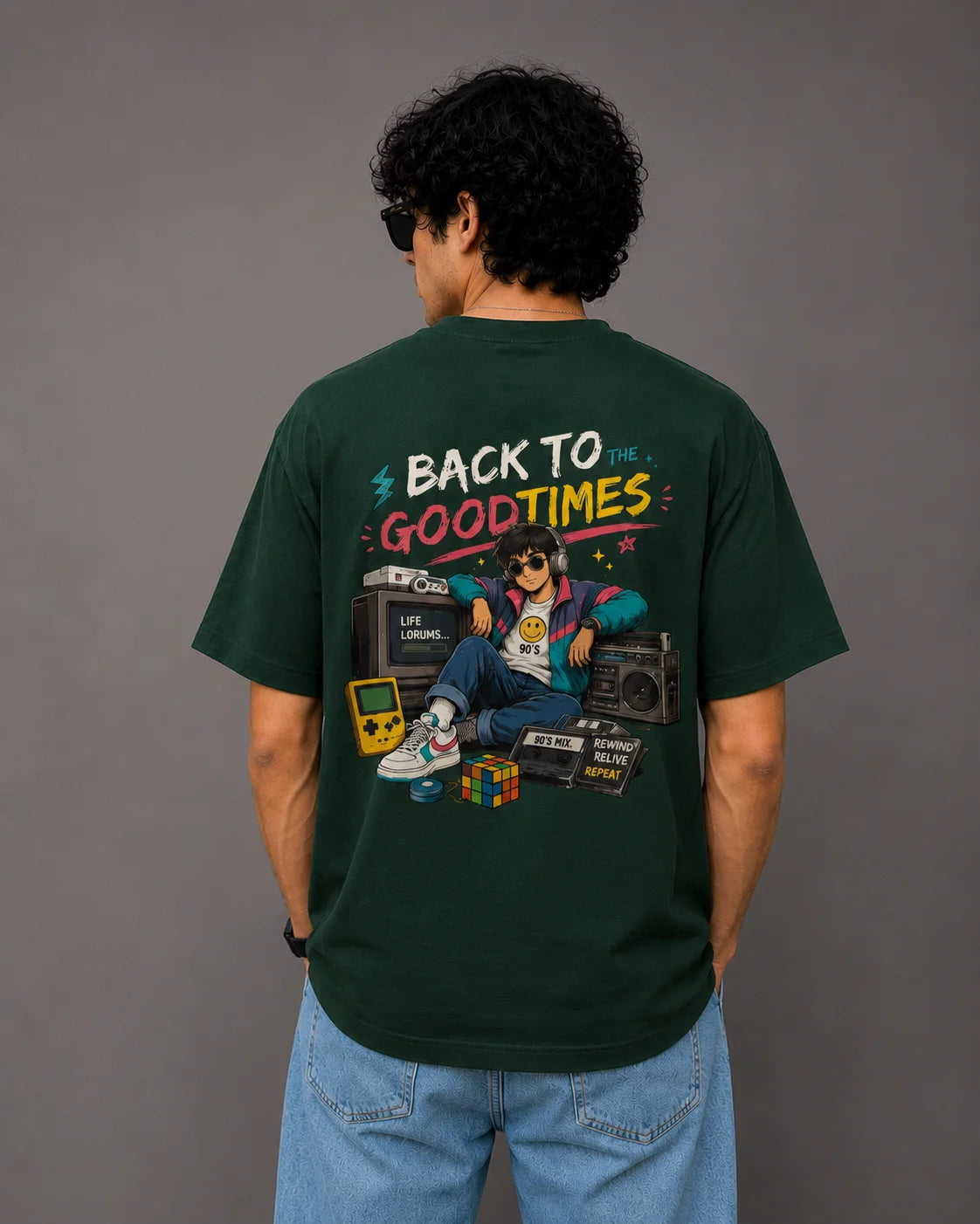 Person wearing a green t-shirt with a graphic design on the back against a gray background