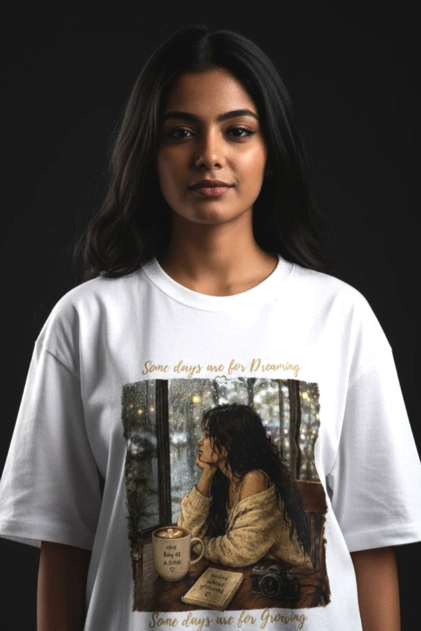 Person wearing a white t-shirt with a graphic design on a dark background