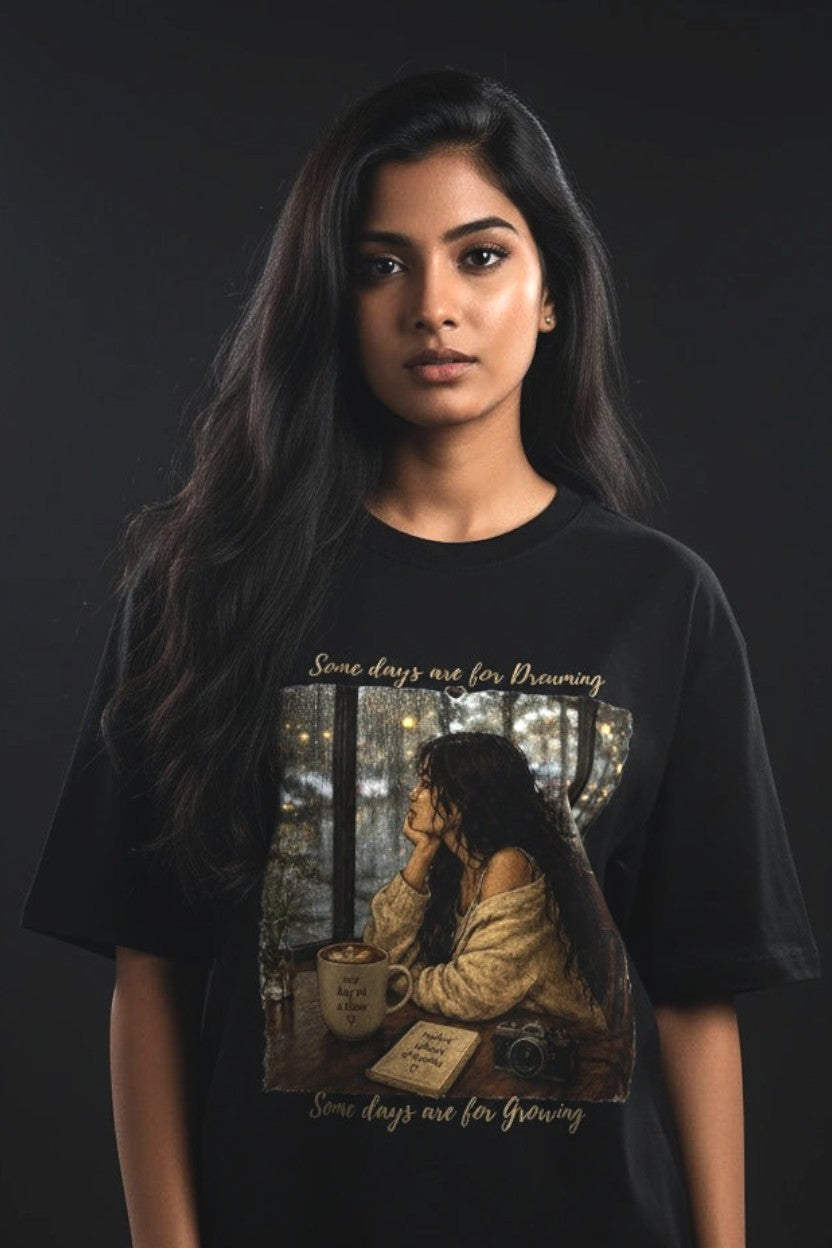Person wearing a black t-shirt with a graphic design on a dark background