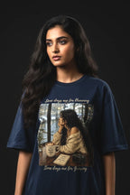 Woman wearing a blue t-shirt with a graphic design on a black background