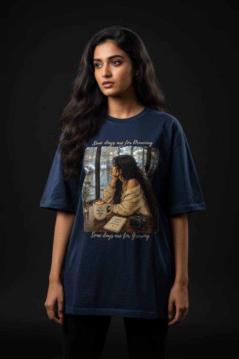 Woman wearing a blue t-shirt with a graphic design on a black background