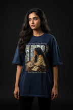 Woman wearing a blue t-shirt with a graphic design on a black background