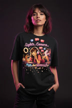 Person wearing a black t-shirt with colorful graphic design on a dark background