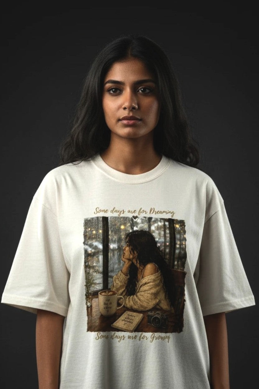 Person wearing a white t-shirt with a graphic design on a dark background
