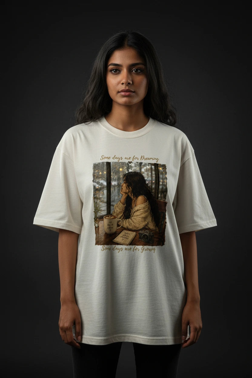 Person wearing a white t-shirt with a graphic design on a dark background