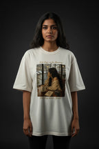 Person wearing a white t-shirt with a graphic design on a dark background