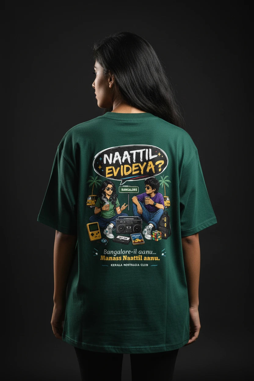 Person wearing a green t-shirt with a graphic design on the back against a dark background