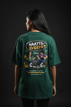 Person wearing a green t-shirt with a graphic design on the back against a dark background