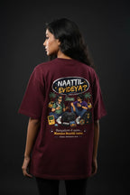 Person wearing a maroon t-shirt with a graphic design on the back against a black background