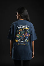 Person wearing a blue t-shirt with a graphic design on the back against a black background