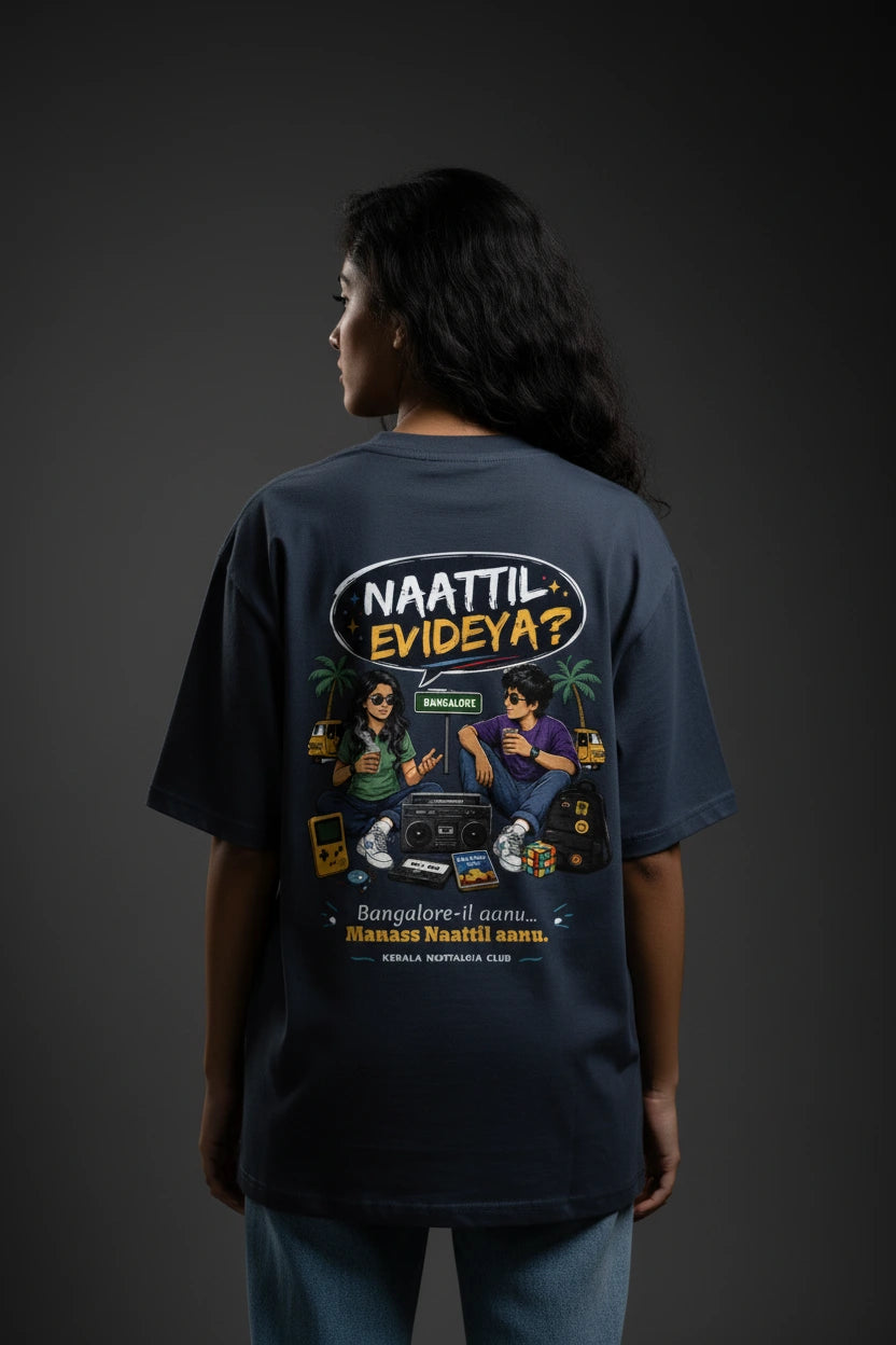Person wearing a Blue T-shirt with colorful graphics and text on the back against a dark background