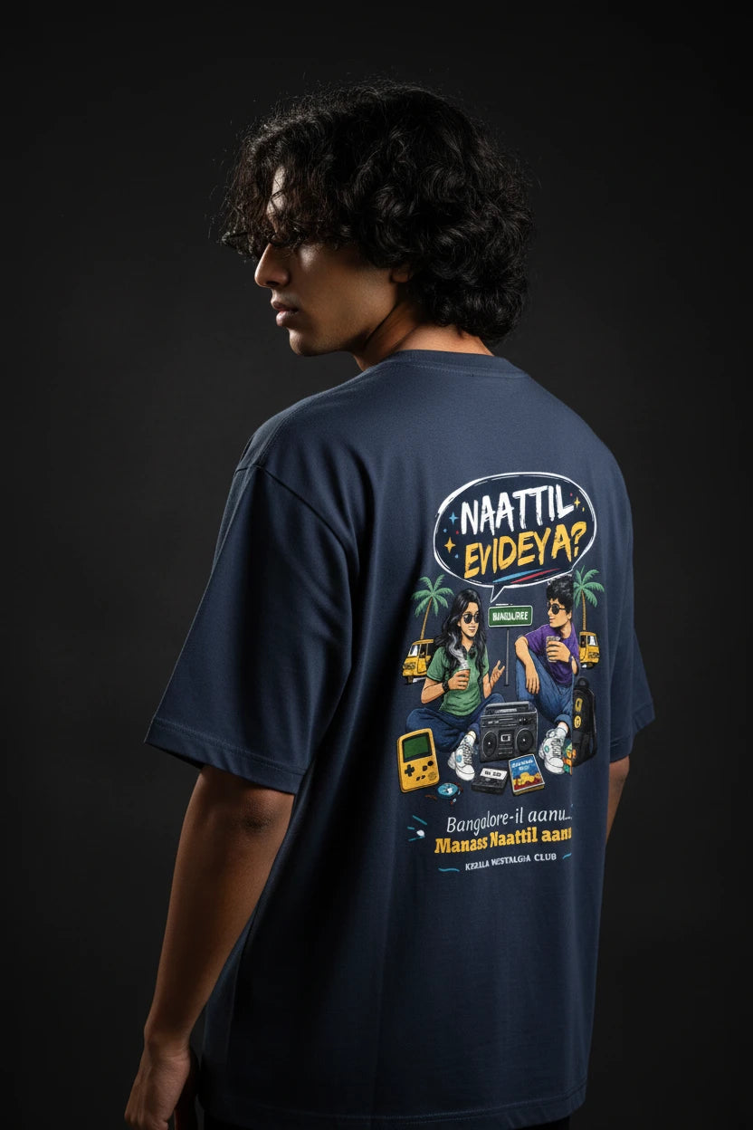 Person wearing a navy blue t-shirt with a graphic design on the back against a black background