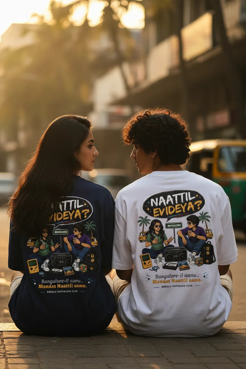 Two people sitting outdoors wearing t-shirts with graphic designs and text.