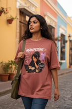 vcreate4uhub.co.in dusty rose graphic t-shirt with "Manifesting Dream Believe Work Achieve" slogan and illustration of a woman working on a laptop.